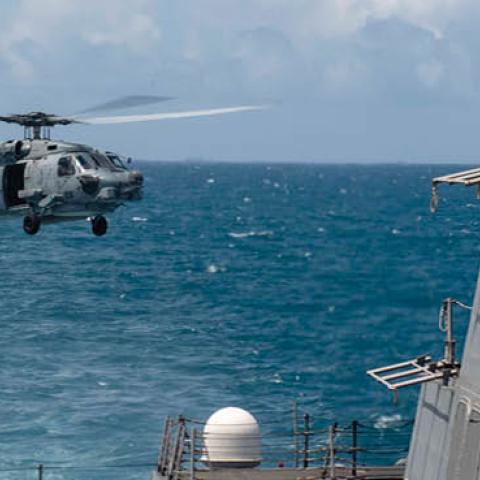 An MH-60R helicopter, assigned to Helicopter Maritime Strike Squadron 51, takes off from the flight deck as the Arleigh Burke-class guided-missile destroyer USS Mustin (DDG 89) conducts routine operations  (U.S. Navy)