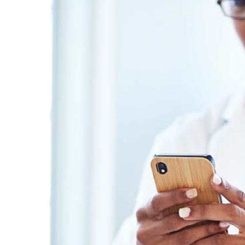 A medical professional uses her cell phone to access patient data. (Getty Images)