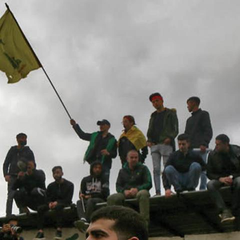 Pro-Iranian Hezbollah militants hold flags and shout slogans during the funeral procession of five men who were killed in clashes with Turkish army in the Syrian province of Idlib. (Marwan Naamani via Getty Images)