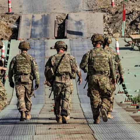 U.S. soldiers patrol an area near Syria's northeastern Semalka border crossing with Iraq's Kurdish autonomous territory, on November 1, 2021. (Photo by DELIL SOULEIMAN/AFP via Getty Images)