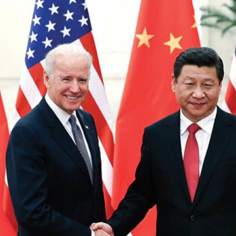 U.S. President Joe Biden shakes hands with Xi Jinping inside the Great Hall of the People on December 4, 2013 in Beijing, China. (Photo by Lintao Zhang/Getty Images)