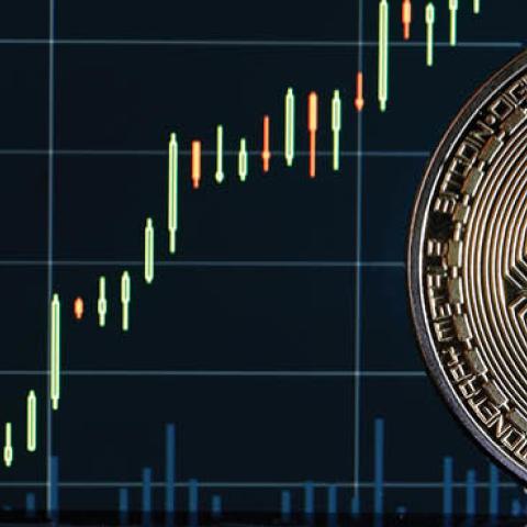 A visual representation of the digital Cryptocurrency Bitcoin is on display in front of the Bitcoin course's graph on October 21, 2021 in Paris, France. (Photo illustration by Chesnot/Getty Images)