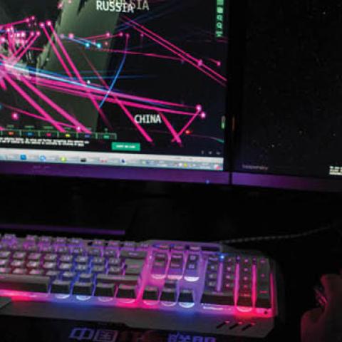 A member of the hacking group Red Hacker Alliance  monitors global cyberattacks on his computer in Dongguan, China. (Photo by NICOLAS ASFOURI/AFP via Getty Images)