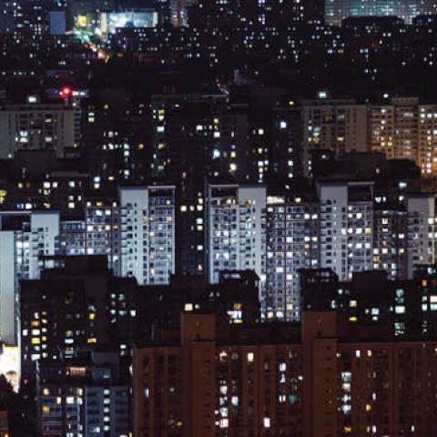 Aerial view of residential buildings at night. (AedalPerspective Image/Getty Images)