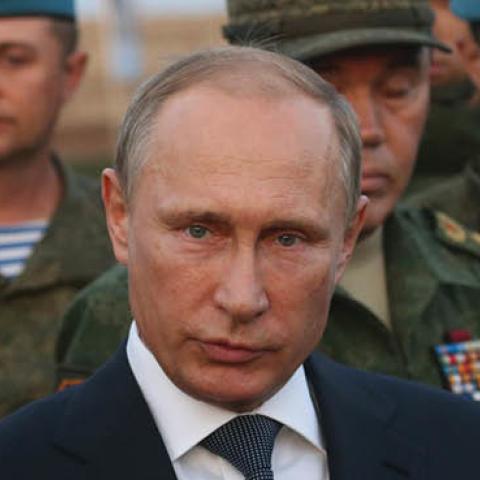 Russian President Vladimir Putin talks to officers as he attends Russias large-scale Center-2015 military exercises at Donguzsky Range September 19, 2015 in Orenburg, Russia. (Photo by Sasha Mordovets/Getty Images)