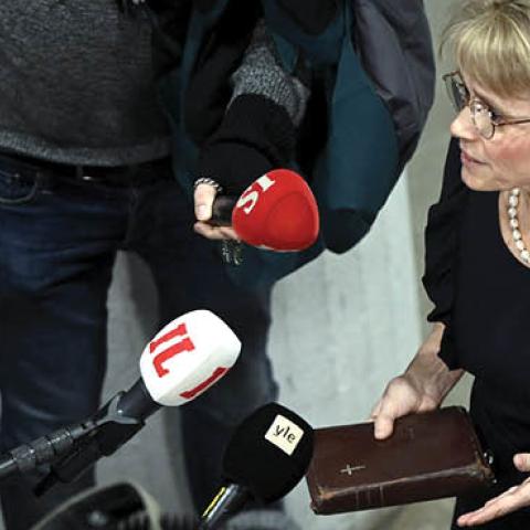 MP of the Finland's Christian Democrats Paivi Rasanen holds a bible as she speaks to media ahead of a court session at the Helsinki District Court in Helsinki, Finland on January 24, 2022. (Photo by Antti Aimo-Koivisto/AFP via Getty Images)