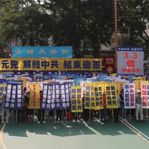 Members of the Falun Gong spiritual group, a group banned in mainland China, gather to protest at a playground in the Sham Shui Po district in Hong Kong on October 1, 2019. (Photo by MAY JAMES/AFP via Getty Images)
