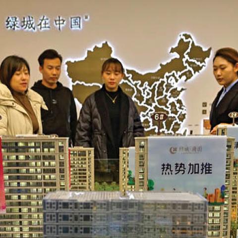 Home buyers look at models at a real estate sales office in Qingzhou city, East China's Shandong Province, Dec 21, 2021. (Wang Jilin/Costfoto/Future Publishing via Getty Images)