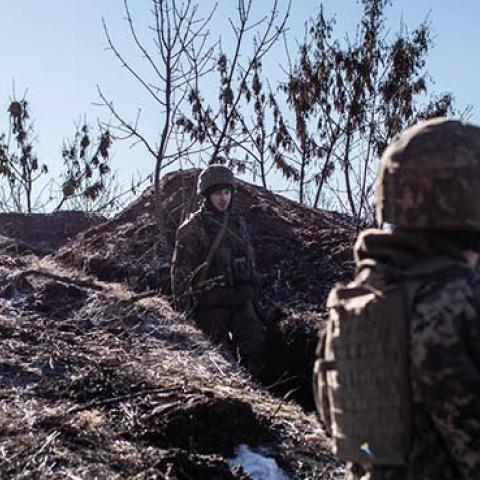 A Ukrainian servicemen stands in a trench at the contact line near the village of Svitlodarsk, in Ukraine's Donestsk region on February 13, 2022. (Photo by Manu Brabo/Getty Images)
