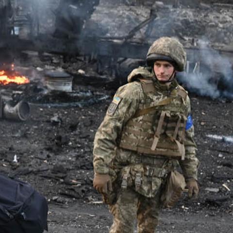 Ukrainian service members look for and collect unexploded shells after a fighting with Russian raiding group in the Ukrainian capital of Kyiv on February 26, 2022. (Photo by Sergei Supinsky/AFP via Getty Images)