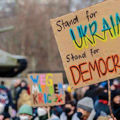 People gather in front of T-34 tank at a Soviet War Memorial to protest against the ongoing war in Ukraine on February 27, 2022 in Berlin, Germany. (Photo by Hannibal Hanschke/Getty Images)