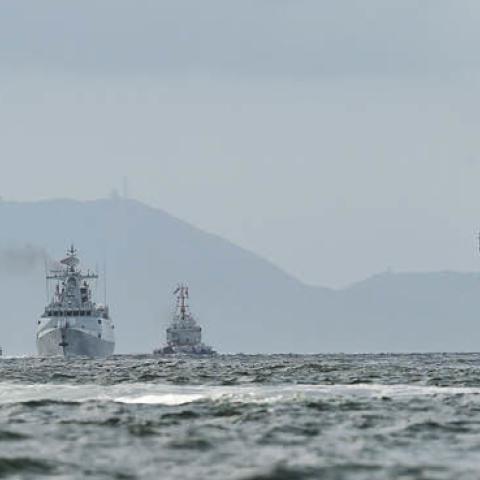 China's sole aircraft carrier, the Liaoning (R), arrives in Hong Kong waters on July 7, 2017. (Anthony Wallace/AFP via Getty Images)