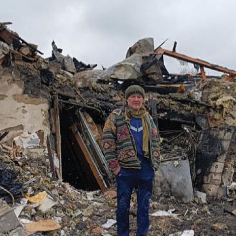 A Ukrainian man stands in the rubble in Zhytomyr on March 02, 2022, following a Russian bombing the day before. (Photo by Emmanuel Duparcq/AFP via Getty Images)