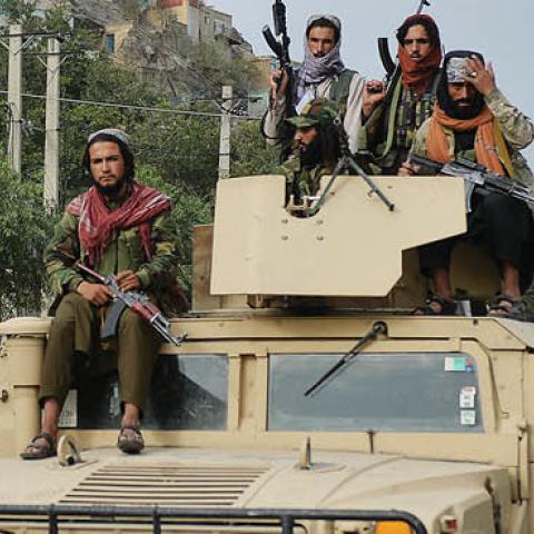 Taliban fighters atop a Humvee vehicle take part in a rally in Kabul on August 31, 2021. (Photo by Hoshang Hashimi/AFP via Getty Images)