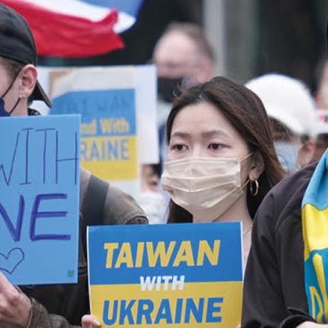 Protesters hold signs expressing their opinion during a protest against Russia's military invasion of Ukraine at the Liberty square in Taipei. (Photo by Walid Berrazeg/SOPA Images/LightRocket via Getty Images)