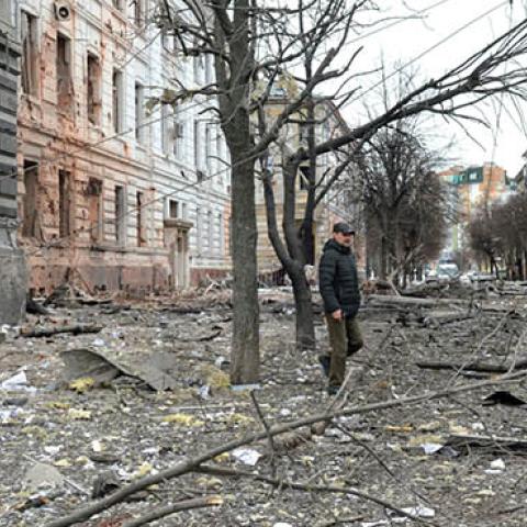 A pedestrian walks amid debris following a shelling in Ukraine's second-biggest city of Kharkiv on March 7, 2022. (Photo by Sergey Bobok/AFP via Getty Images)