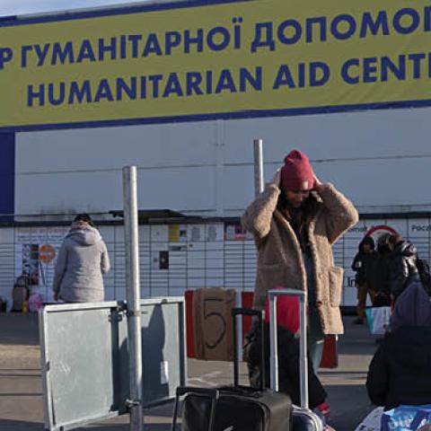 Families who have arrived from war-torn Ukraine stand outside a makeshift shelter and transit center on March 12, 2022 in Przemysl, Poland. (Photo by Sean Gallup/Getty Images)
