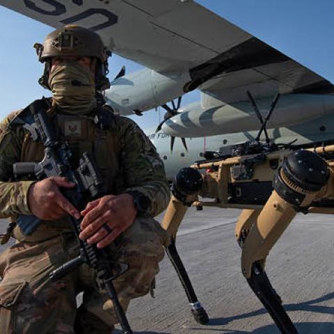 A member of the 321st Contingency Response Squadron security team stands next to a Ghost Robotics Vision 60 prototype during the Advanced Battle Management System exercise on Nellis Air Force Base, Nevada, Sept. 1, 2020. (US Air Force)