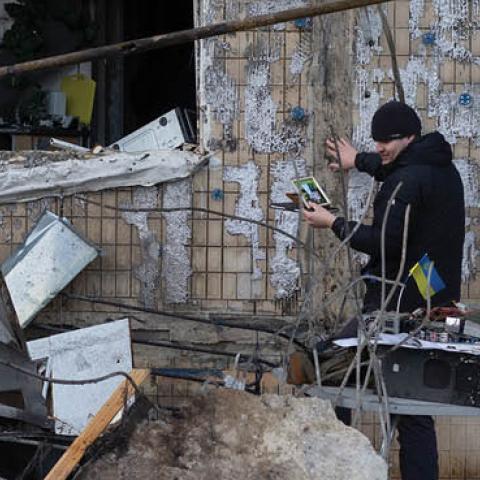 People remove rubble following the shelling of a residential area on March 14, 2022 in Kyiv, Ukraine. (Photo by Anastasia Vlasova/Getty Images)