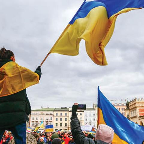 A protester is seen waving a Ukrainian flag during a demonstration in Krakow, Poland on February 27, 2022. (Getty Images)