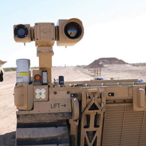 A soldier interacts with an unmanned ground vehicle during Project Convergence 2021. (U.S. Army/Marita Schwab)