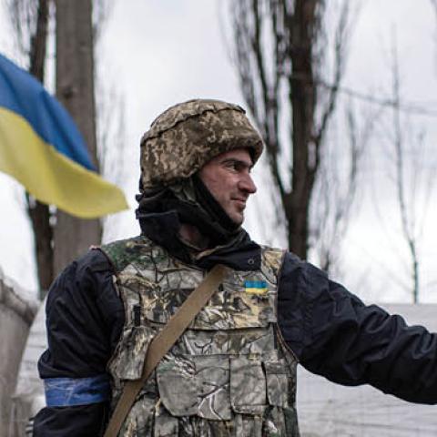 A territorial defense member signals to cars passing a checkpoint on April 3, 2022 in Kyiv, Ukraine. (Photo by Alexey Furman/Getty Images)