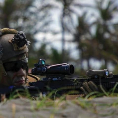 A Marine simulates providing security for an amphibious landing in Appari, Philippines, March 28, 2022, during Balikatan, a bilateral exercise between the U.S. and Philippines. (Photo by United States Marine Corps)