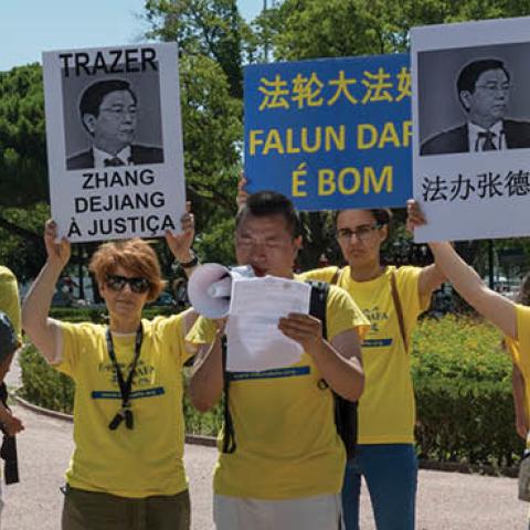 Members of the Portuguese chapter of Falun Gong demonstrate outside Belem Palace on July 12, 2017 in Lisbon, Portugal. (Photo by Horacio Villalobos/Corbis via Getty Images)