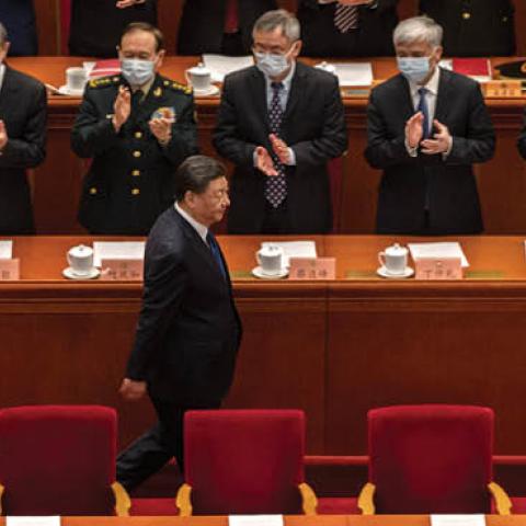 Chinese leader Xi Jinping is applauded by members of his government as he arrives for the closing session of the National People's Congress at the Great Hall of the People on March 11, 2022 in Beijing, China. (Kevin Frayer/Getty Images)