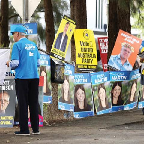 Campaign signs are seen outside the entrance to a voting center at the Homebush West Community center on May 10, 2022 in Sydney, Australia. (Photo by Mark Kolbe/Getty Images)