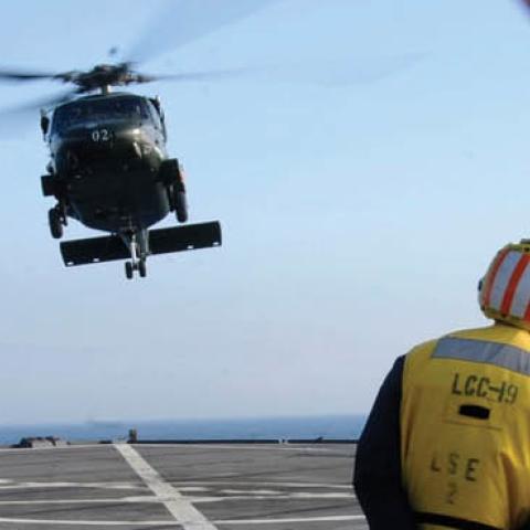 The amphibious command ship USS Blue Ridge flight deck crew prepare to land an SH-60B Sea Hawk assigned to Light Helicopter Antisubmarine squadron 51 on the flight deck. (U.S. Navy)