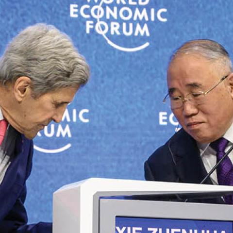 U.S. climate envoy John Kerry and China's special climate envoy Xie Zhenhua during a session at the World Economic Forum annual meeting in Davos on May 24, 2022. (Photo by Fabrice Coffrini/AFP via Getty Images)