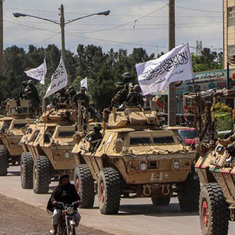 Taliban fighters in armoured vehicles take part in a military street parade in Herat on April 19, 2022.  (Photo by Mohsen Karimi/AFP via Getty Images)