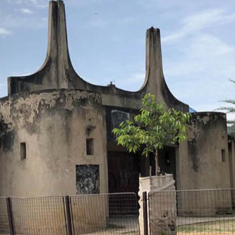 The black flags of “Boko Haram” are still visible on this building (pictured August 2021), which “Boko Haram” used as a prison and execution grounds during its occupation of Gwoza town in Borno state from 2014 to 2015. (James Barnett)