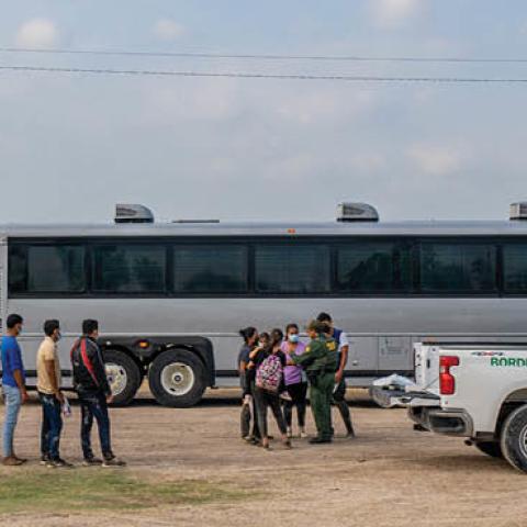 Migrants wait in line to be processed after crossing the Rio Grande into the U.S. on May 03, 2022 in La Joya, Texas. (Photo by Brandon Bell/Getty Images)