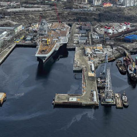 Russian Navyâs lone aircraft carrier, the Admiral Flota Sovetskogo Soyuza Kuznetsov, is towed to the 35th squadron shipyard for maintenance and repair works in Murmansk, Russia on May 20, 2022. (Photo by Semen Vasileyev/Anadolu Agency via Getty Images)