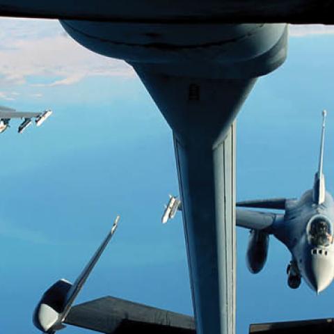 Two F-16 Fighting Falcons fly in formation behind a KC-10 Extender from Al Dhafra Air Base, United Arab Emirates, Dec. 25, 2021. (U.S. Air Force)