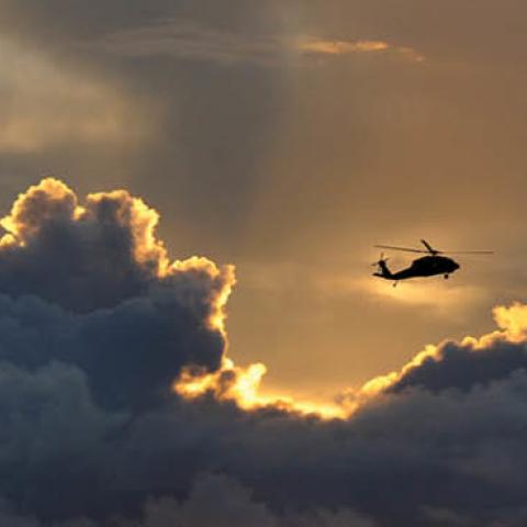 A military helicopter flies over the waters of Agana Bay in Hagatna, Guam, on Aug. 10, 2015. (Tiffany Tompkins-Condie/McClatchy DC/Tribune News Service via Getty Images)