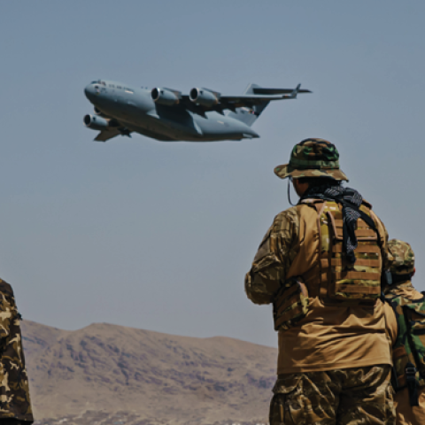 A C-17 Globemaster takes off as Taliban fighters secure the outer perimeter alongside the American controlled side of of the Hamid Karzai International Airport in Kabul, Afghanistan, on Sunday, Aug. 29, 2021. (Marcus Yam / Los Angeles Times)