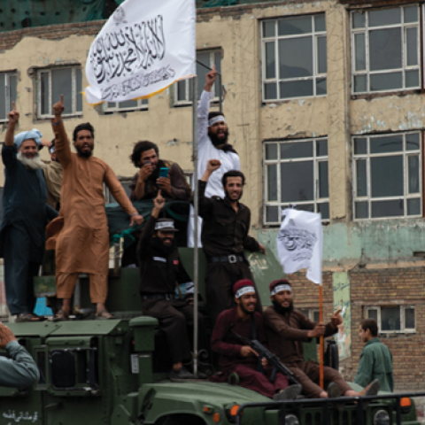 Taliban members ride on top of an armored vehicle on August 15, 2022, during a celebration of the first anniversary of the Taliban's return to power in Kabul, Afghanistan. (Nava Jamshidi/Getty Images)