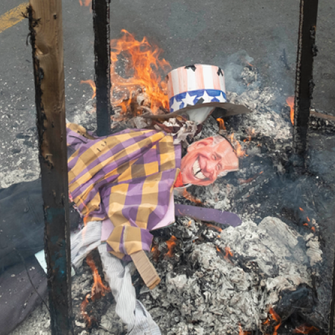Iranian demonstrators burn an effigy of President Joe Biden in downtown Tehran during a rally commemorating the International Quds Day on April 29, 2022. (Morteza Nikoubazl/NurPhoto via Getty Images)
