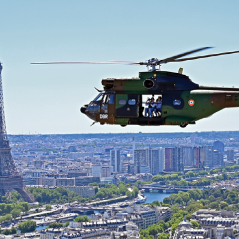 A French army Puma helicopter flies over the Eiffel Tower during an aerial rehearsal parade before Bastille Day on July 11, 2022, in Paris, France. (Photo by Aurelien Meunier/Getty Images)